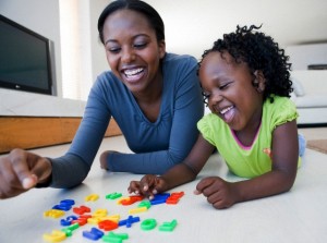 Mother and daughter playing with letters