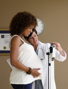 Doctor Weighing Pregnant Woman