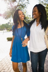 Mother and daughter walking in sunshine