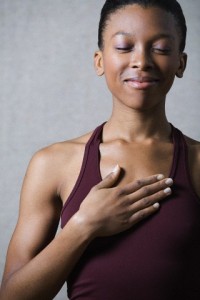 Women breathing deeply, touching chest