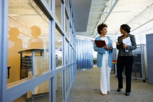 Businesswoman walking down office corridor