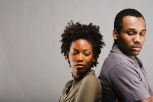 Angry African American couple standing back to back