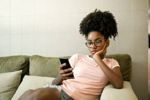 Black Teenager -Female- On Smartphone.